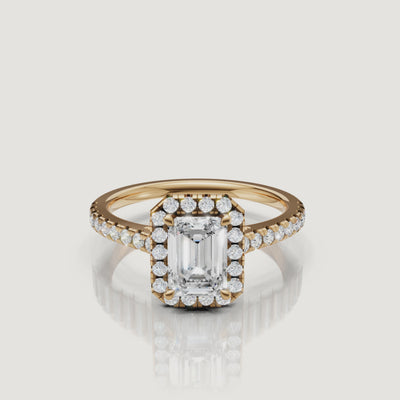 video of emerald cut lab grown diamond halo engagement ring with pavé band in 14k yellow gold