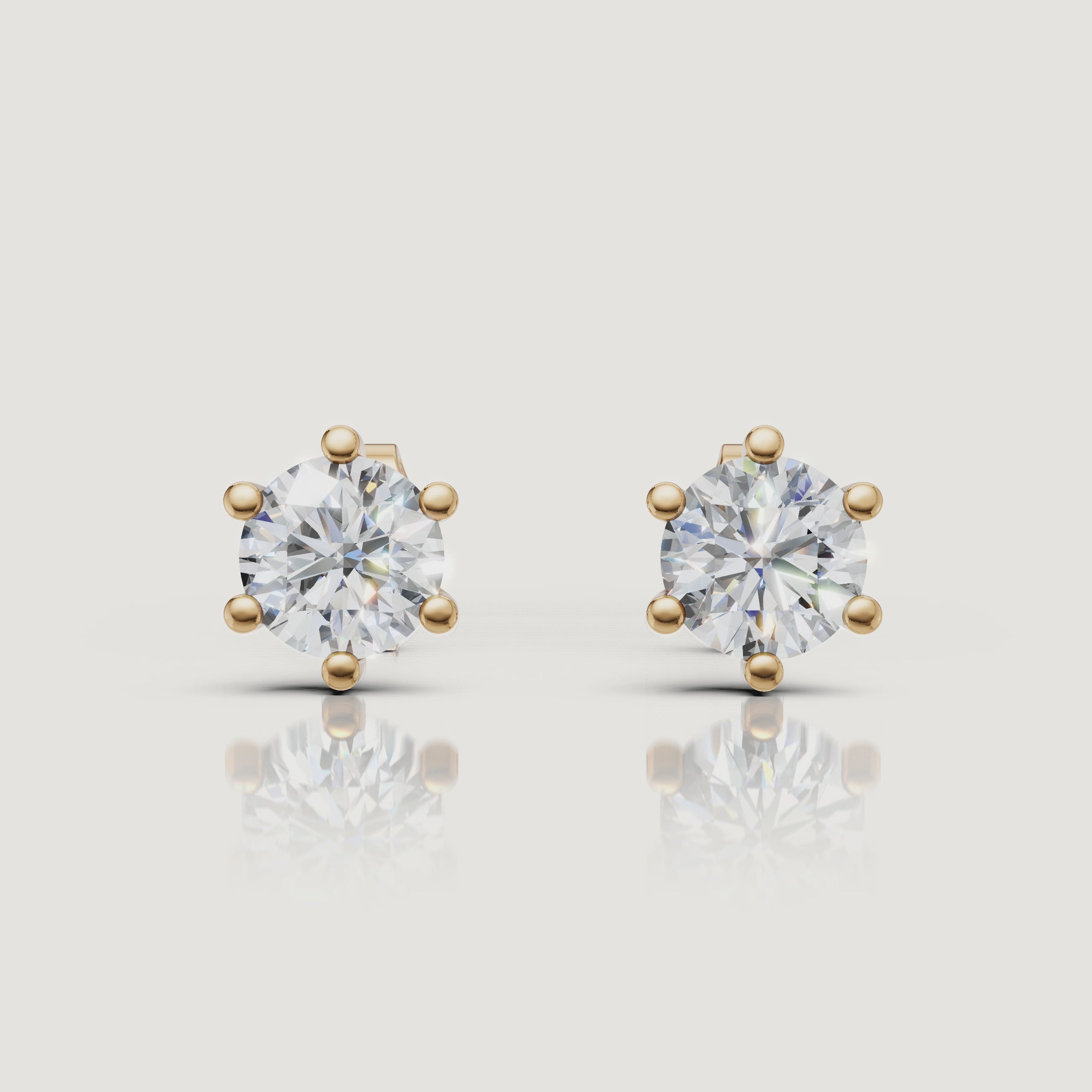 Yellow gold round diamond stud earrings video showcasing brilliant solitaire sparkle by Raul Diamonds