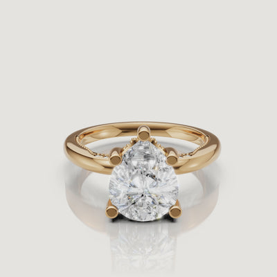 Cinematic 4K video of a Raul Diamonds pear-cut ring in yellow gold, showing the teardrop symmetry and the warm glow of the 18k gold band