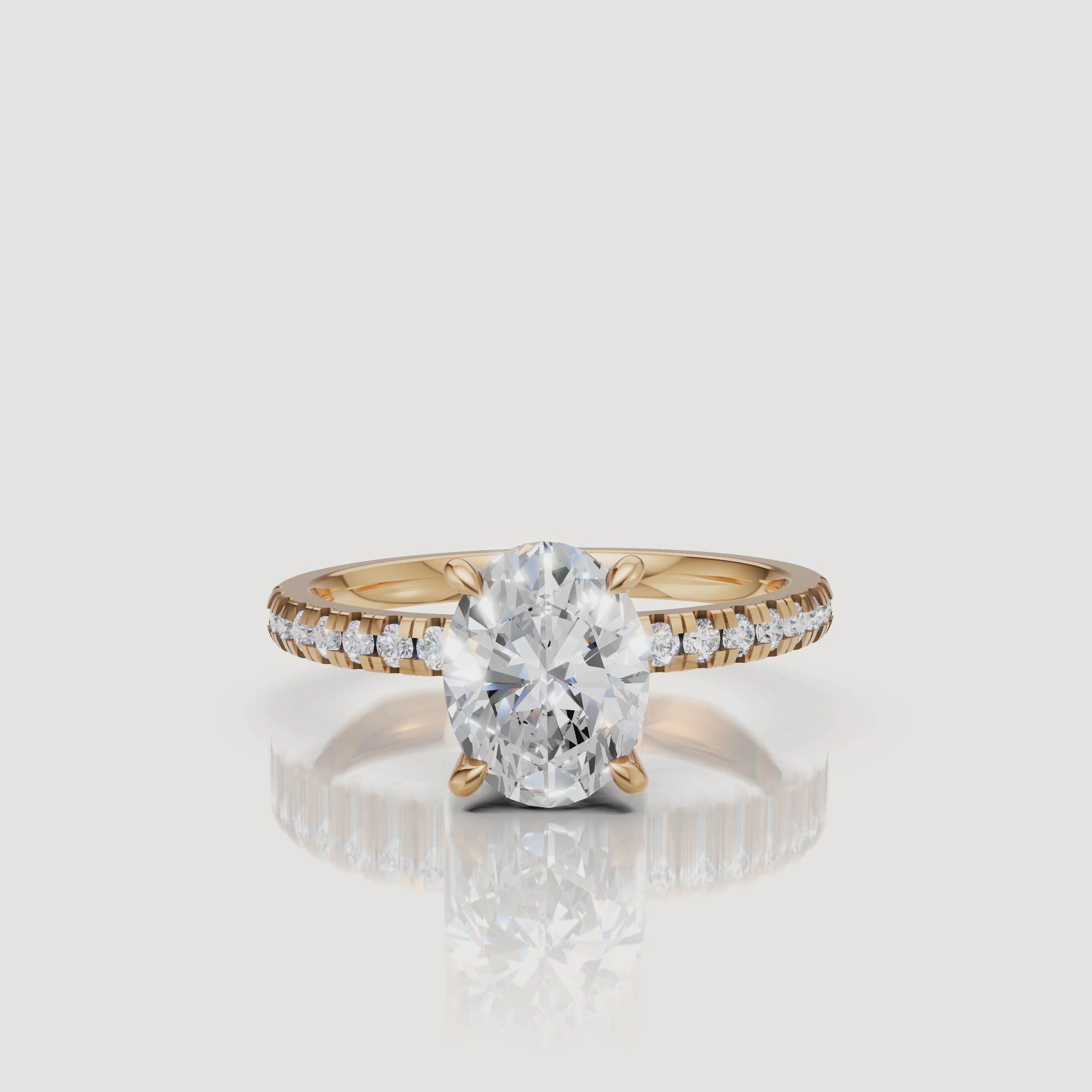 High-resolution video of a Raul Diamonds yellow gold oval engagement ring, showcasing the light performance of the oval diamond and the delicate pavé band