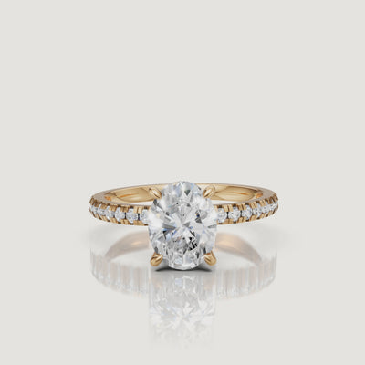 High-resolution video of a Raul Diamonds yellow gold oval engagement ring, showcasing the light performance of the oval diamond and the delicate pavé band