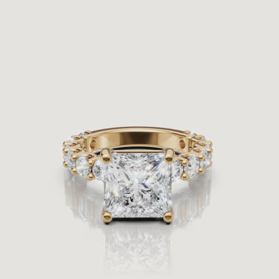 Product video of a Raul Diamonds princess-cut diamond ring in 18k yellow gold, showcasing the sharp brilliance of the square cut and full eternity band