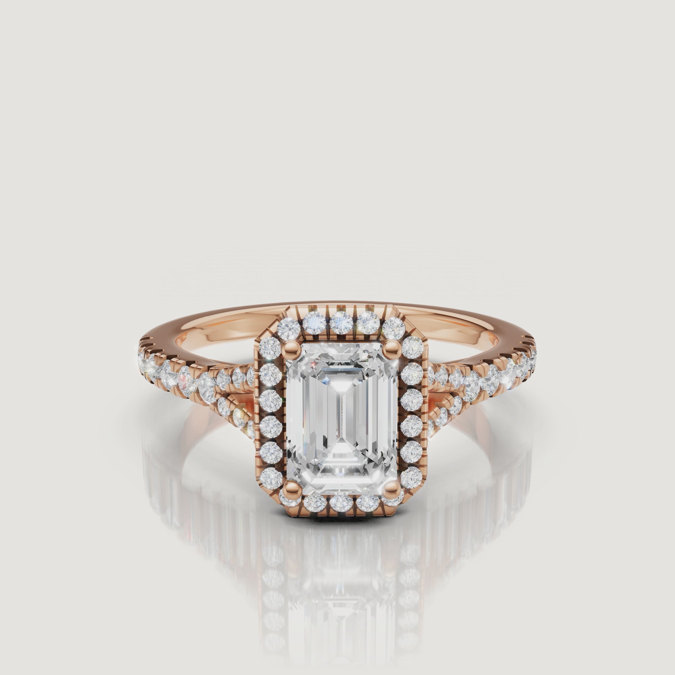 Detailed video showcase of a rose gold emerald cut diamond engagement ring with a pavé halo, highlighting the romantic warmth and brilliance of the Raul Diamonds design