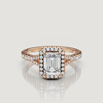 Detailed video showcase of a rose gold emerald cut diamond engagement ring with a pavé halo, highlighting the romantic warmth and brilliance of the Raul Diamonds design