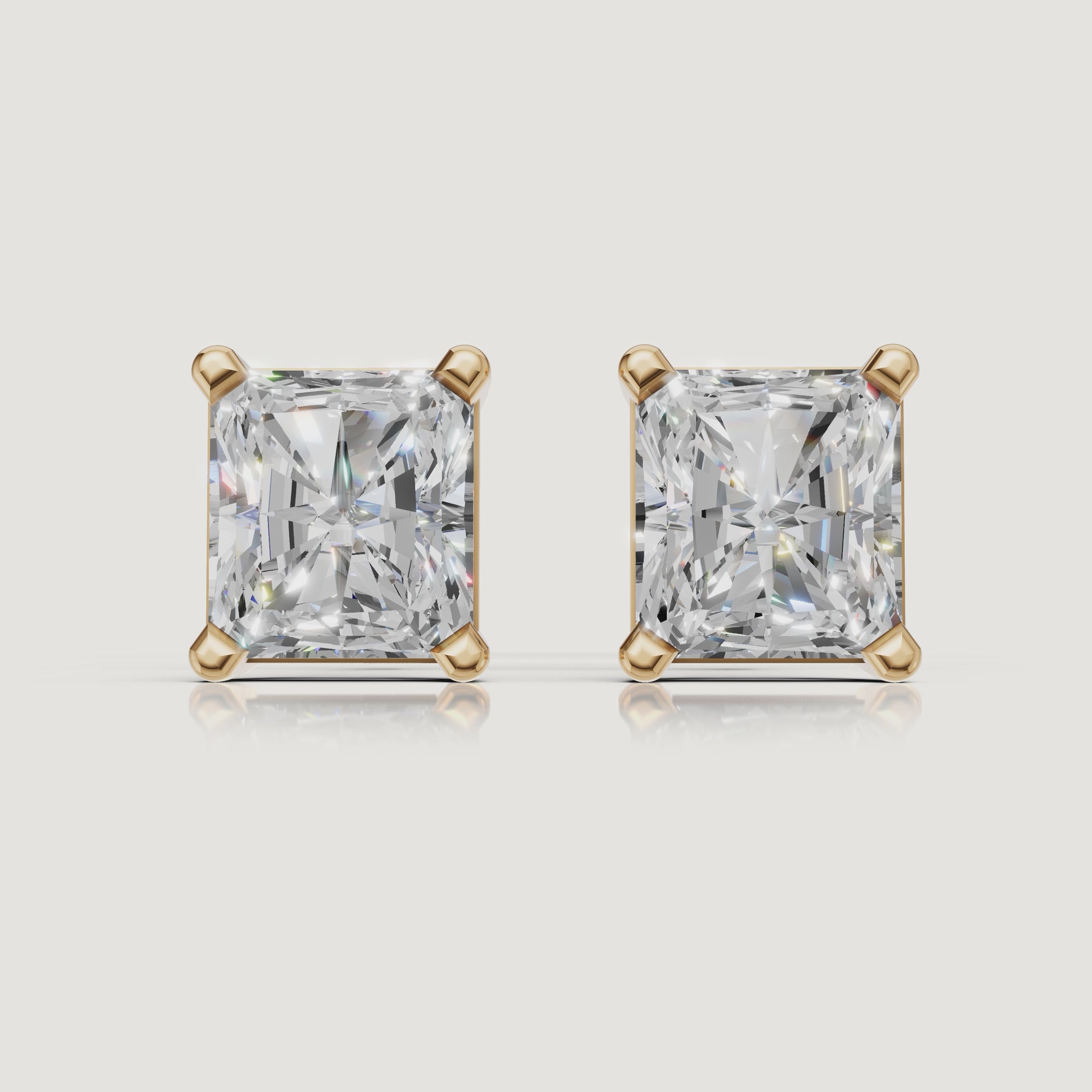 Yellow gold radiant cut diamond stud earrings cinematic jewelry video by Raul Diamonds