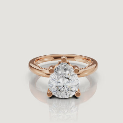 Close-up video of a rose gold pear-shaped diamond ring by Raul Diamonds, capturing the romantic blush tones and the 'crushed ice' sparkle of the facets.