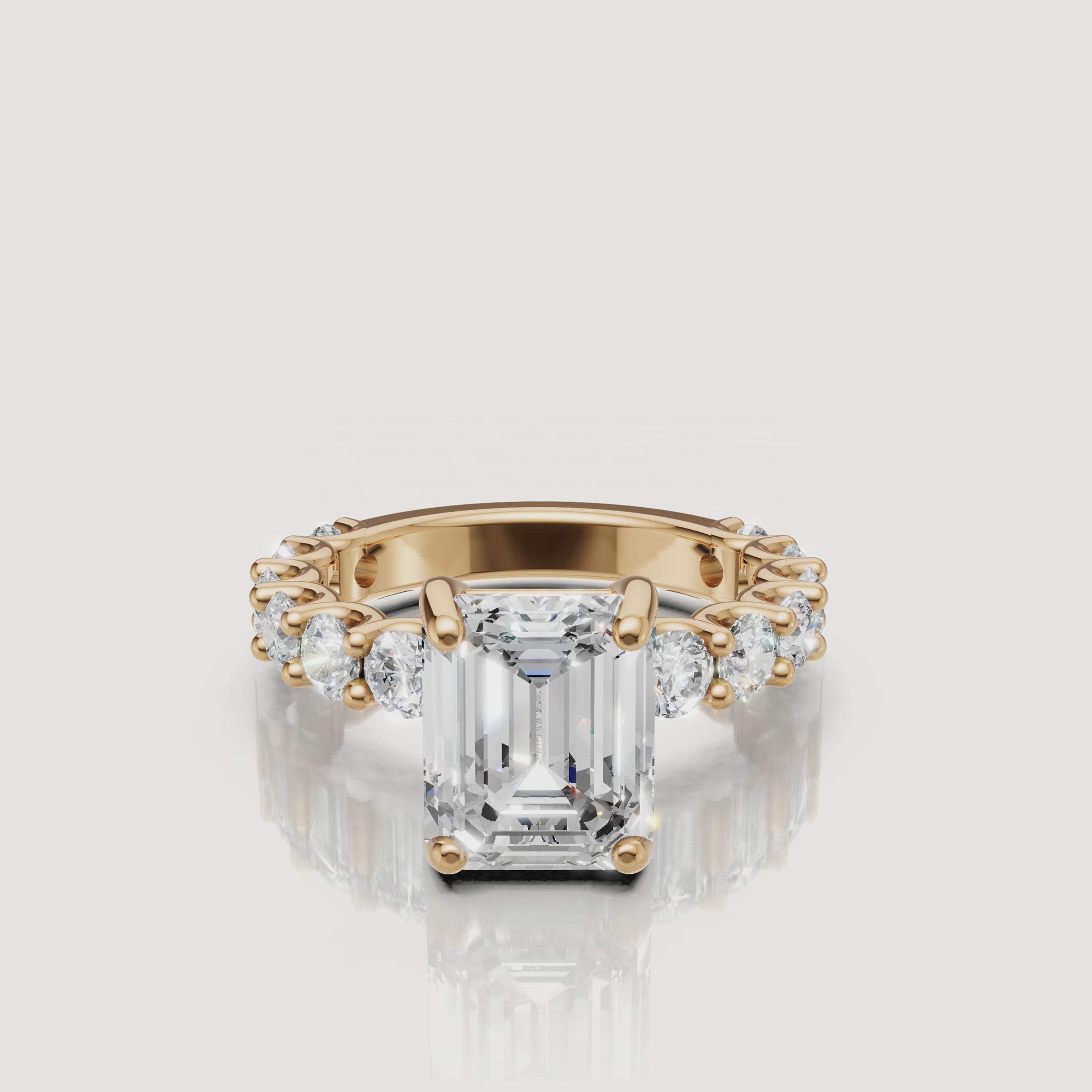 High-definition video of a Raul Diamonds emerald-cut diamond ring in 18k yellow gold, highlighting the hall-of-mirrors effect and eternity band