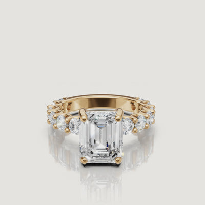 High-definition video of a Raul Diamonds emerald-cut diamond ring in 18k yellow gold, highlighting the hall-of-mirrors effect and eternity band