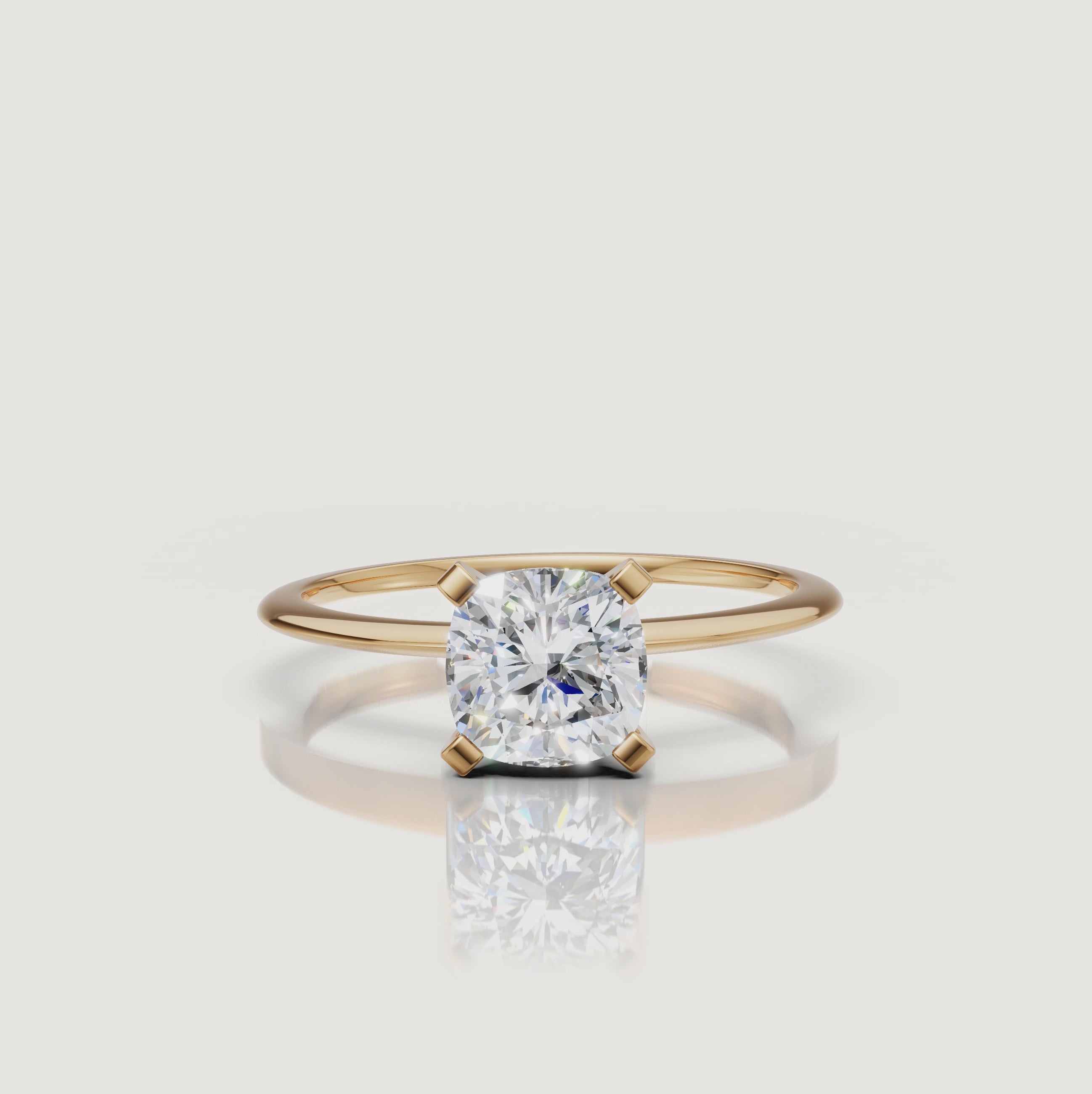 Cinematic video of a cushion cut lab grown diamond solitaire engagement ring in yellow gold by Raul Diamonds featuring elegant hand movement, macro diamond sparkle, warm luxury lighting, and premium bridal jewelry styling