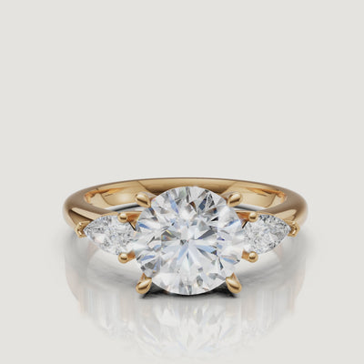 video of round cut lab grown diamond engagement ring with marquise side stones in 14k yellow gold
