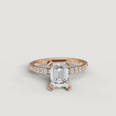 Cinematic close-up of the Celine emerald cut diamond ring in rose gold, highlighting the warm blush metal and high-clarity step-cut facets.