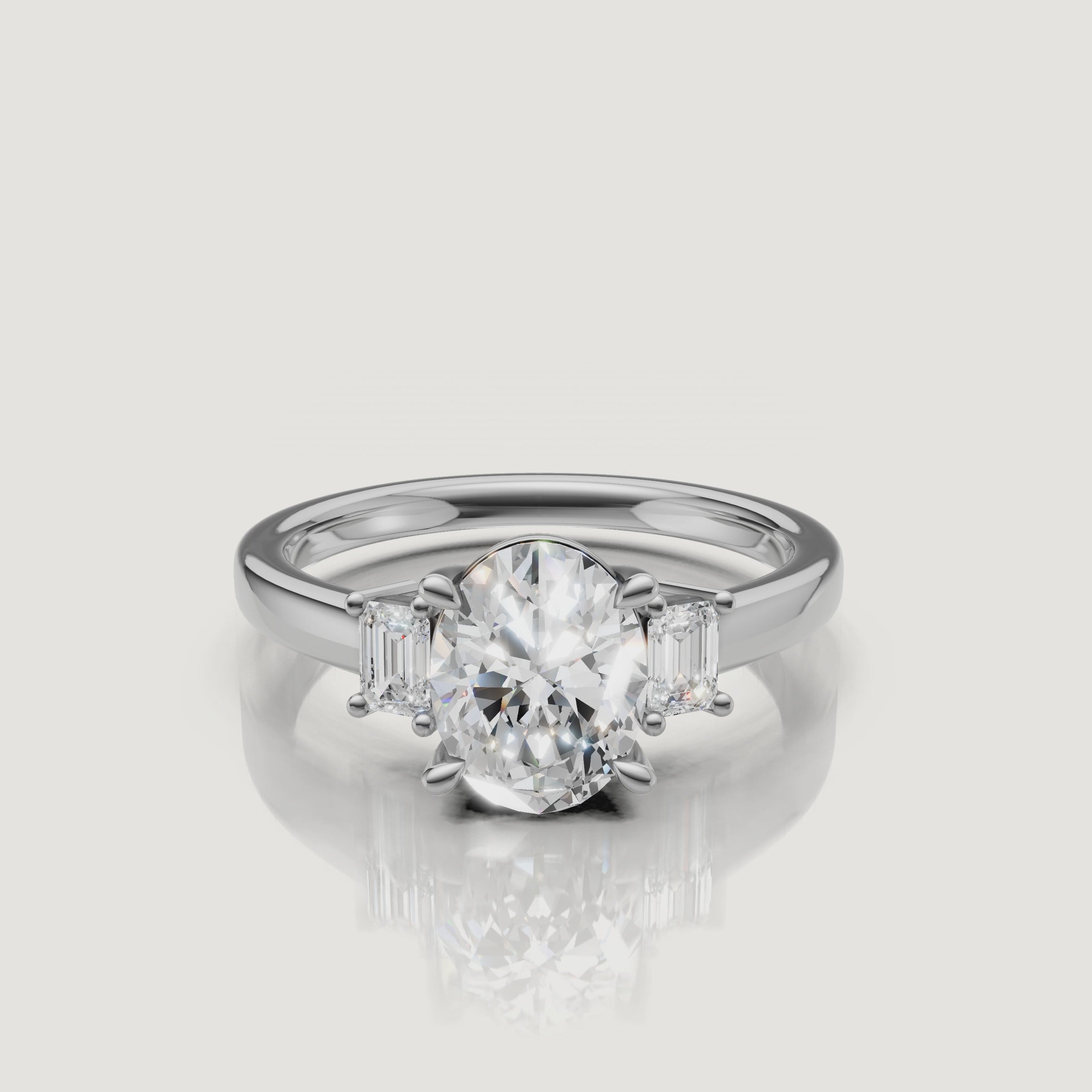 Cinematic product video of a white gold three-stone oval diamond ring, demonstrating the fire and brilliance of the stones as the ring rotates on a white background
