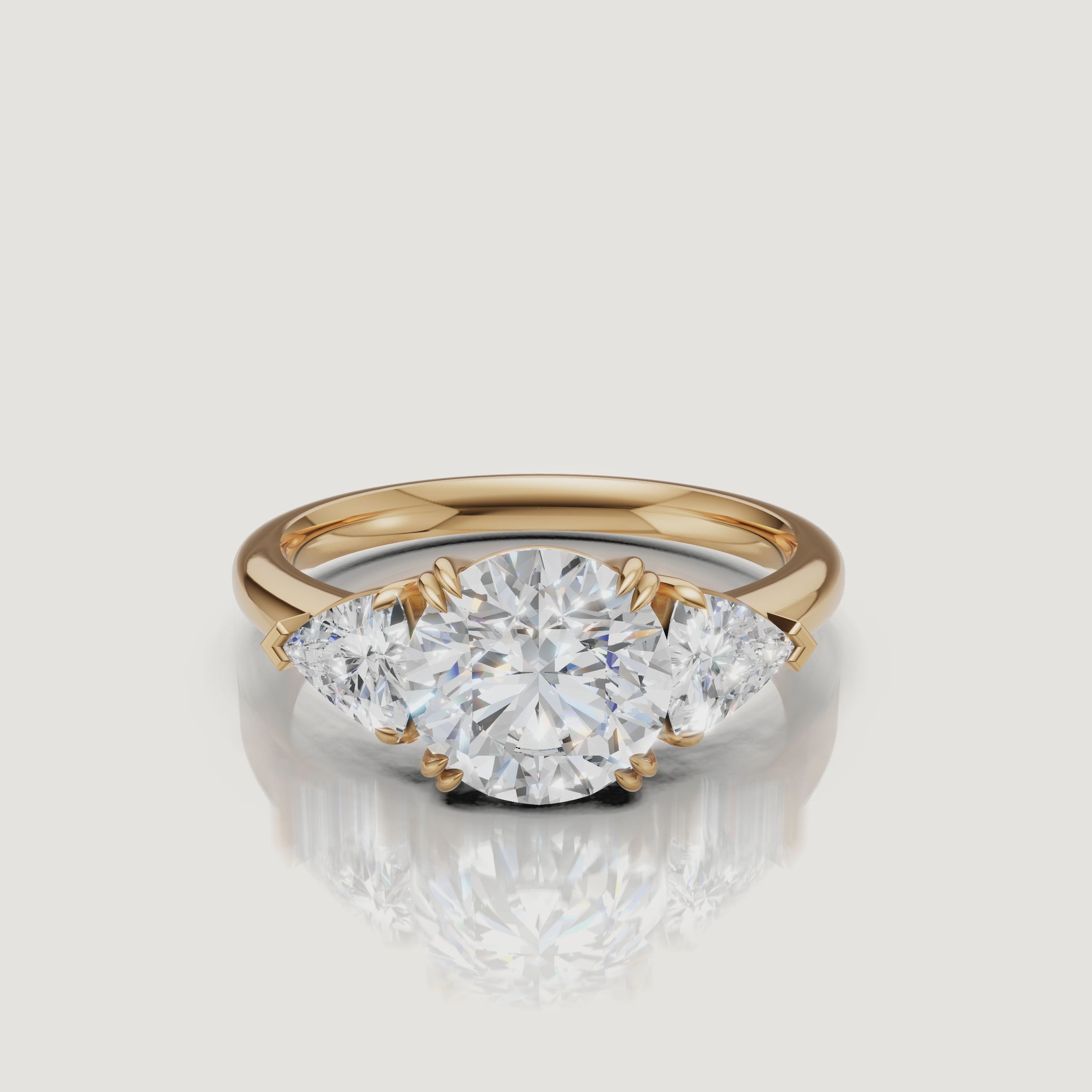 video of round brilliant lab grown diamond engagement ring with trillion side stones in 14k yellow gold