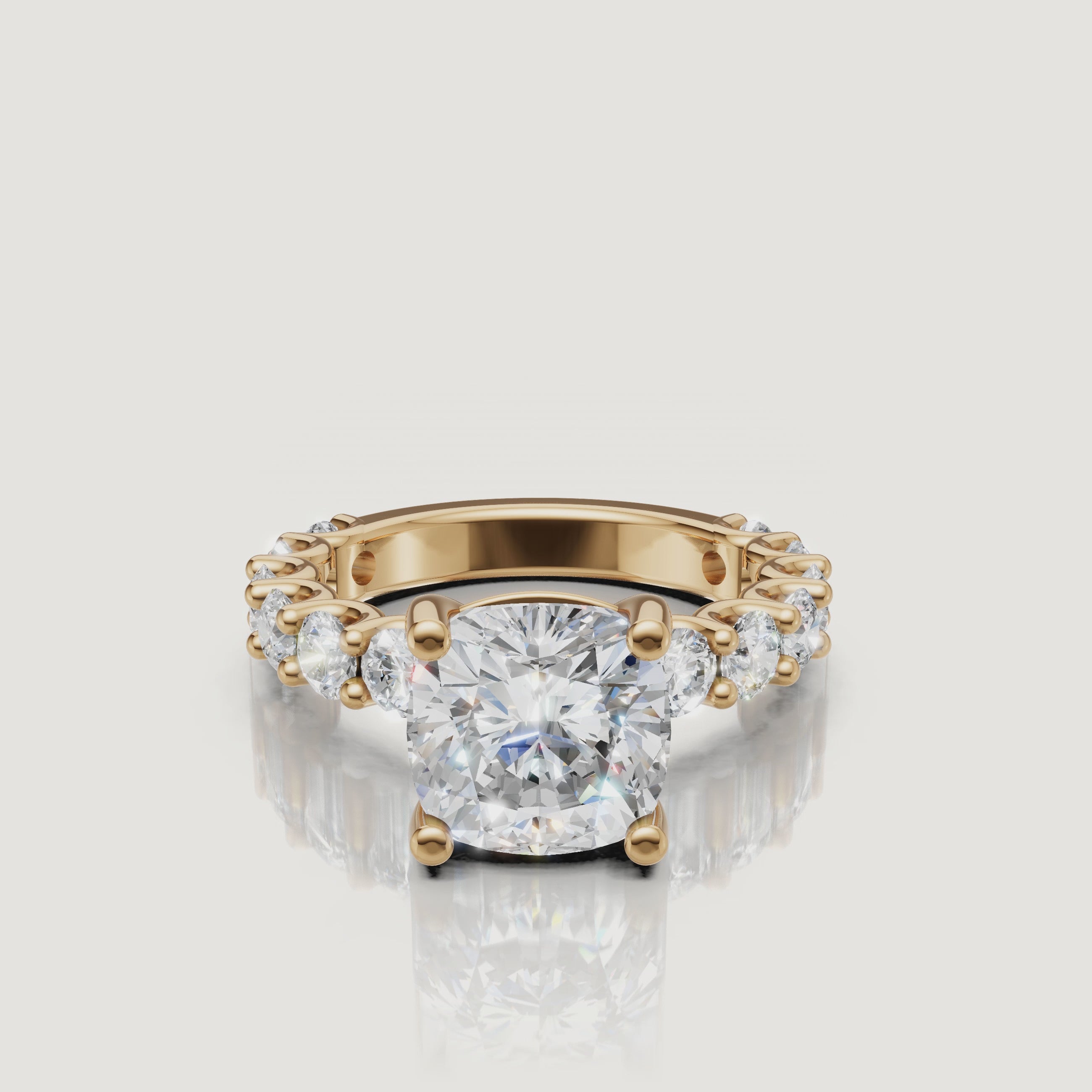 Video showcase of a Raul Diamonds cushion-cut diamond ring in 18k yellow gold, featuring a brilliant hidden halo and eternity band