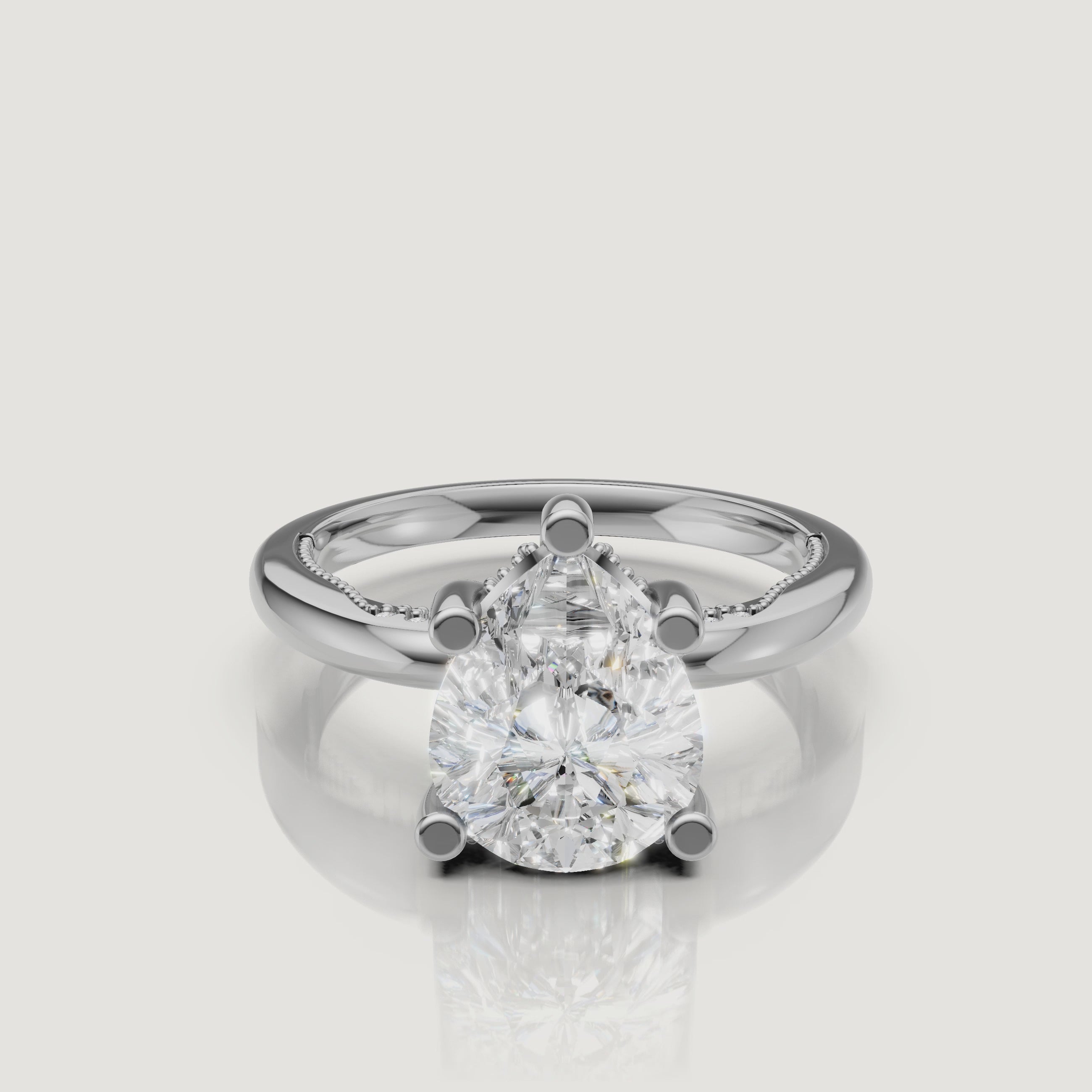 Macro video showcase of a white gold pear-cut solitaire ring by Raul Diamonds, highlighting the crisp point, rounded base, and brilliant light return
