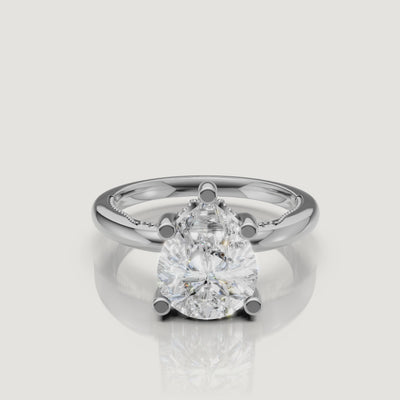 Macro video showcase of a white gold pear-cut solitaire ring by Raul Diamonds, highlighting the crisp point, rounded base, and brilliant light return