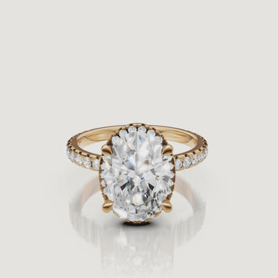 Cinematic 4K video of a Raul Diamonds Oval Cut Hidden Halo ring in 18k yellow gold, featuring a 360-degree view of the pavé diamond shank
