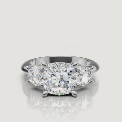 High-definition video of the Raul Diamonds white gold cushion three-stone engagement ring, demonstrating the seamless sparkle between the cushion and round brilliant diamonds.