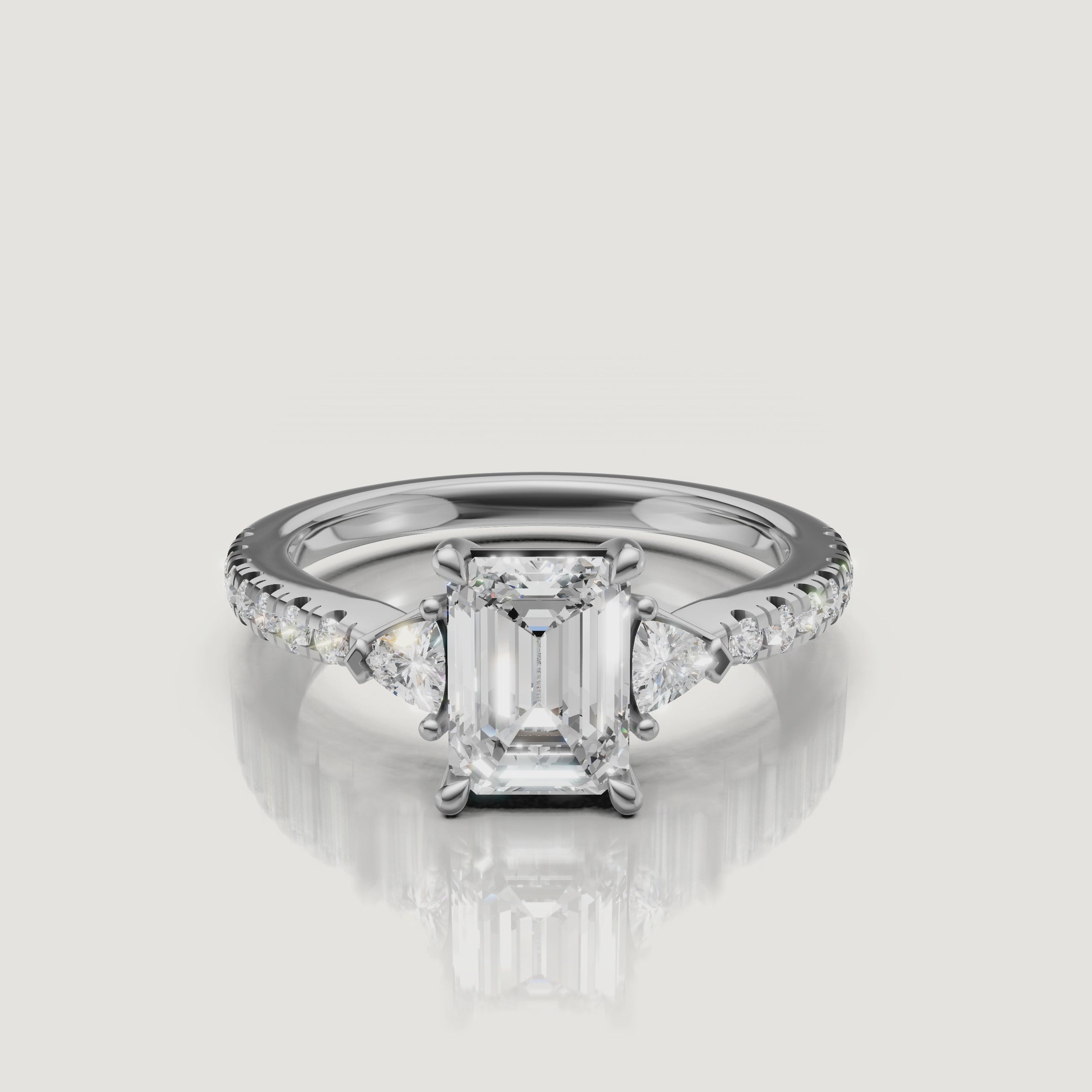 Lifestyle video of a model wearing a Rual Diamonds emerald cut diamond ring in rose gold, showing how the three-stone design looks and reflects light during natural hand movement.