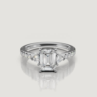 Lifestyle video of a model wearing a Rual Diamonds emerald cut diamond ring in rose gold, showing how the three-stone design looks and reflects light during natural hand movement.