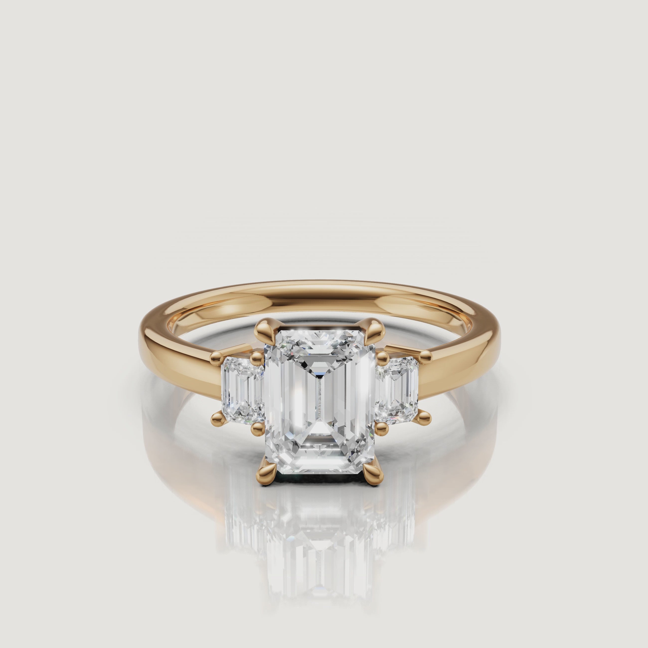 A high-definition 360-degree rotation of a Rual Diamonds double emerald cut linear two-stone ring in 14k yellow gold, showcasing the unique diamond-encrusted pavé bridge bridge and step-cut brilliance