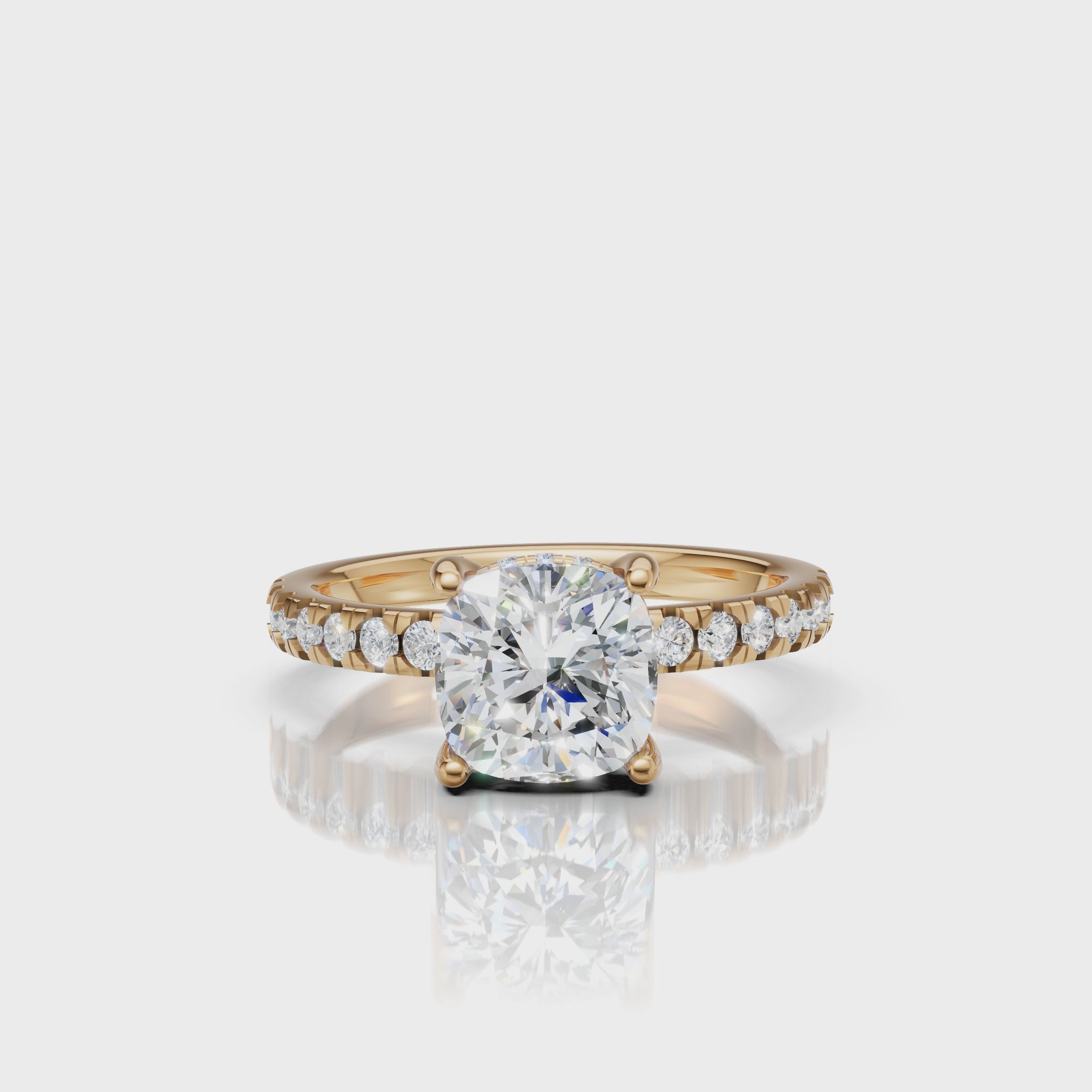 High-definition video showcase of a Raul Diamonds cushion-cut engagement ring in 18k yellow gold, featuring a dazzling hidden halo and diamond-encrusted pavé band.