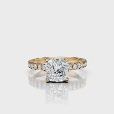 High-definition video showcase of a Raul Diamonds cushion-cut engagement ring in 18k yellow gold, featuring a dazzling hidden halo and diamond-encrusted pavé band.