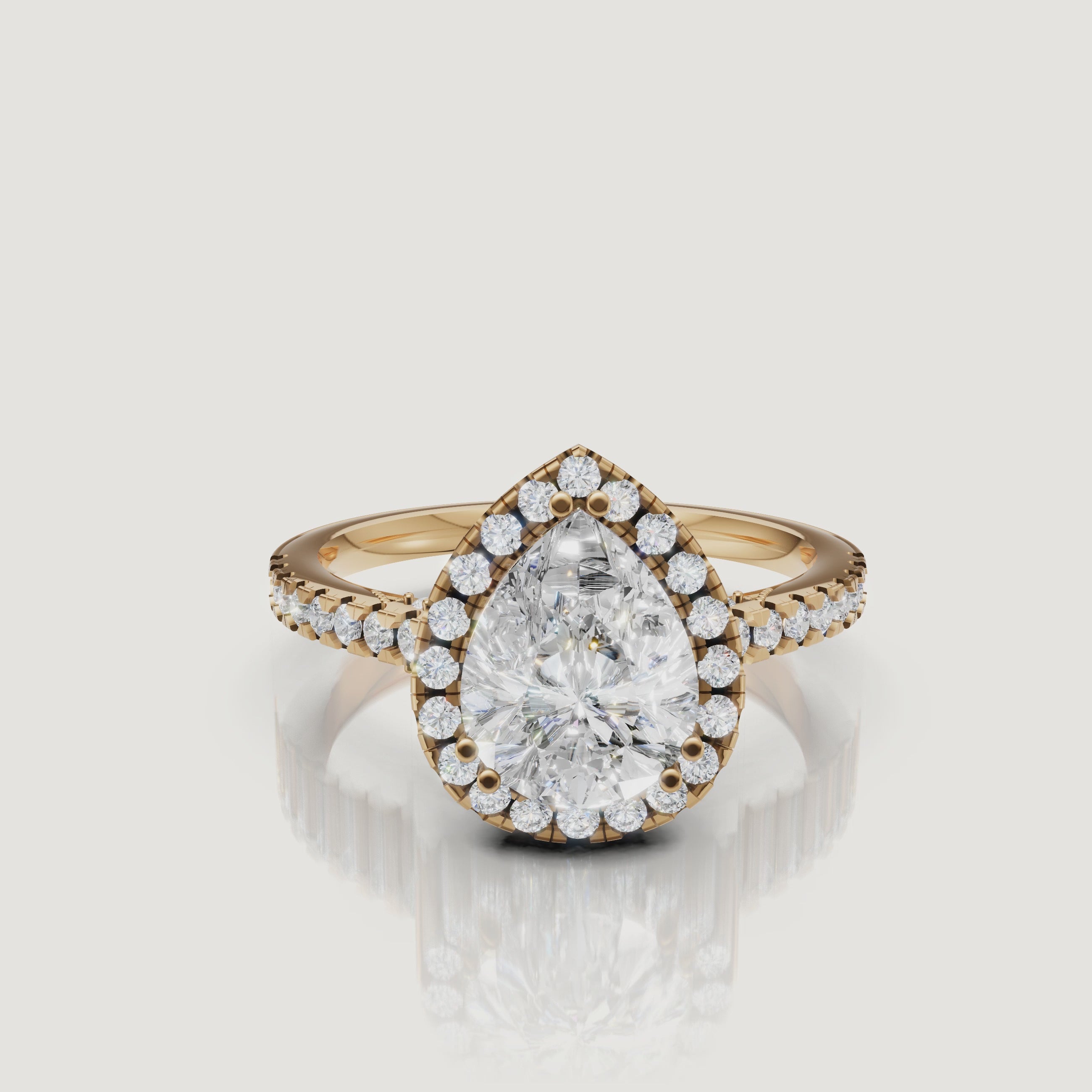 Video of pear cut lab grown diamond halo engagement ring in 14K yellow gold with pavé band by Raul Diamonds