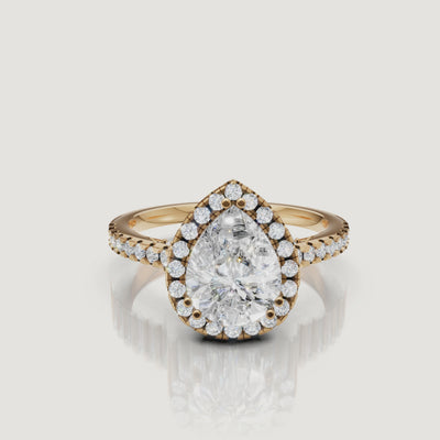 Video of pear cut lab grown diamond halo engagement ring in 14K yellow gold with pavé band by Raul Diamonds