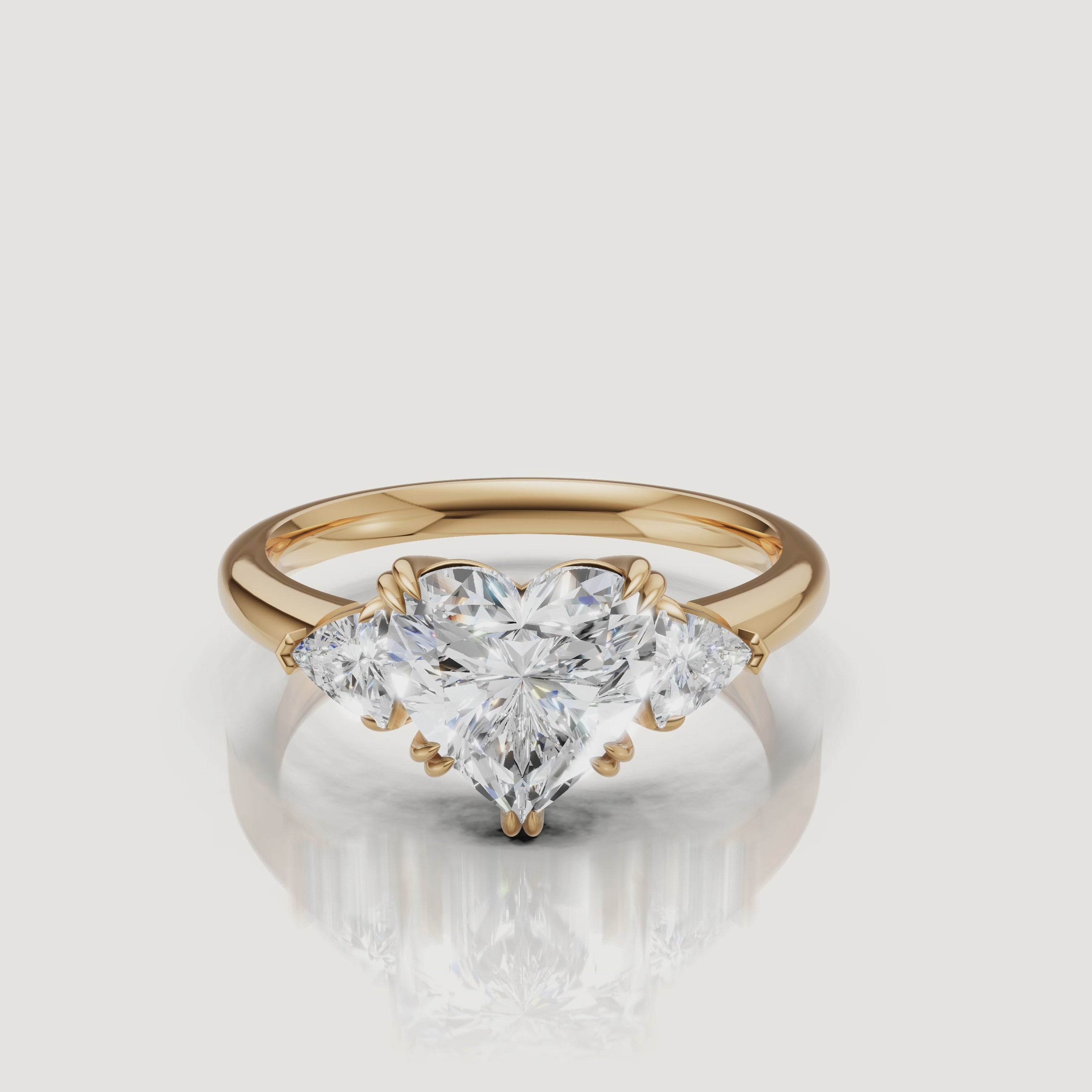 video of heart shaped lab grown diamond engagement ring with trillion side stones in 14k yellow gold
