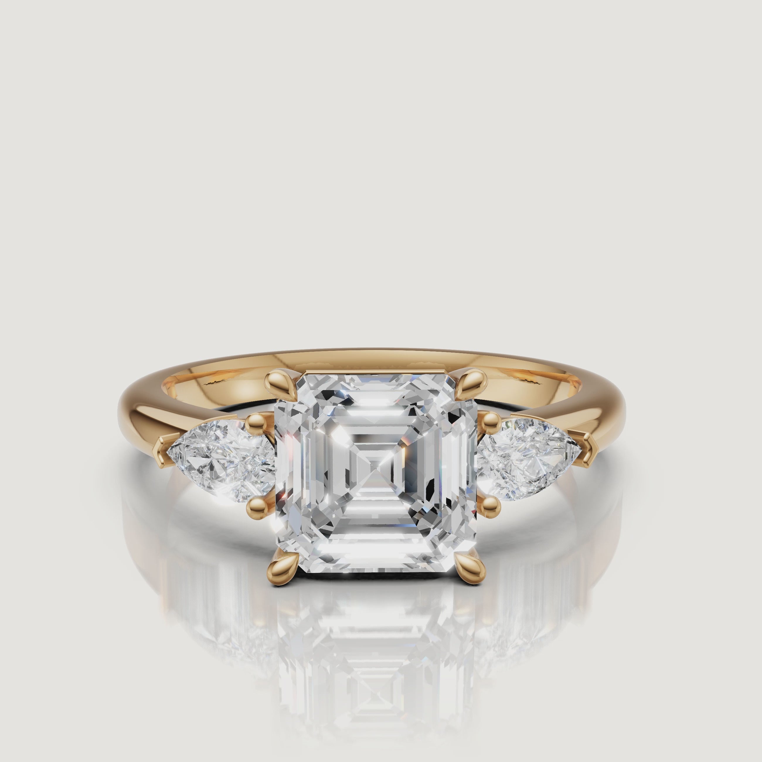 Video showcase of 18k yellow gold Asscher cut diamond ring with pear side stones by Raul Diamonds.