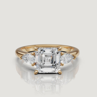 Video showcase of 18k yellow gold Asscher cut diamond ring with pear side stones by Raul Diamonds.