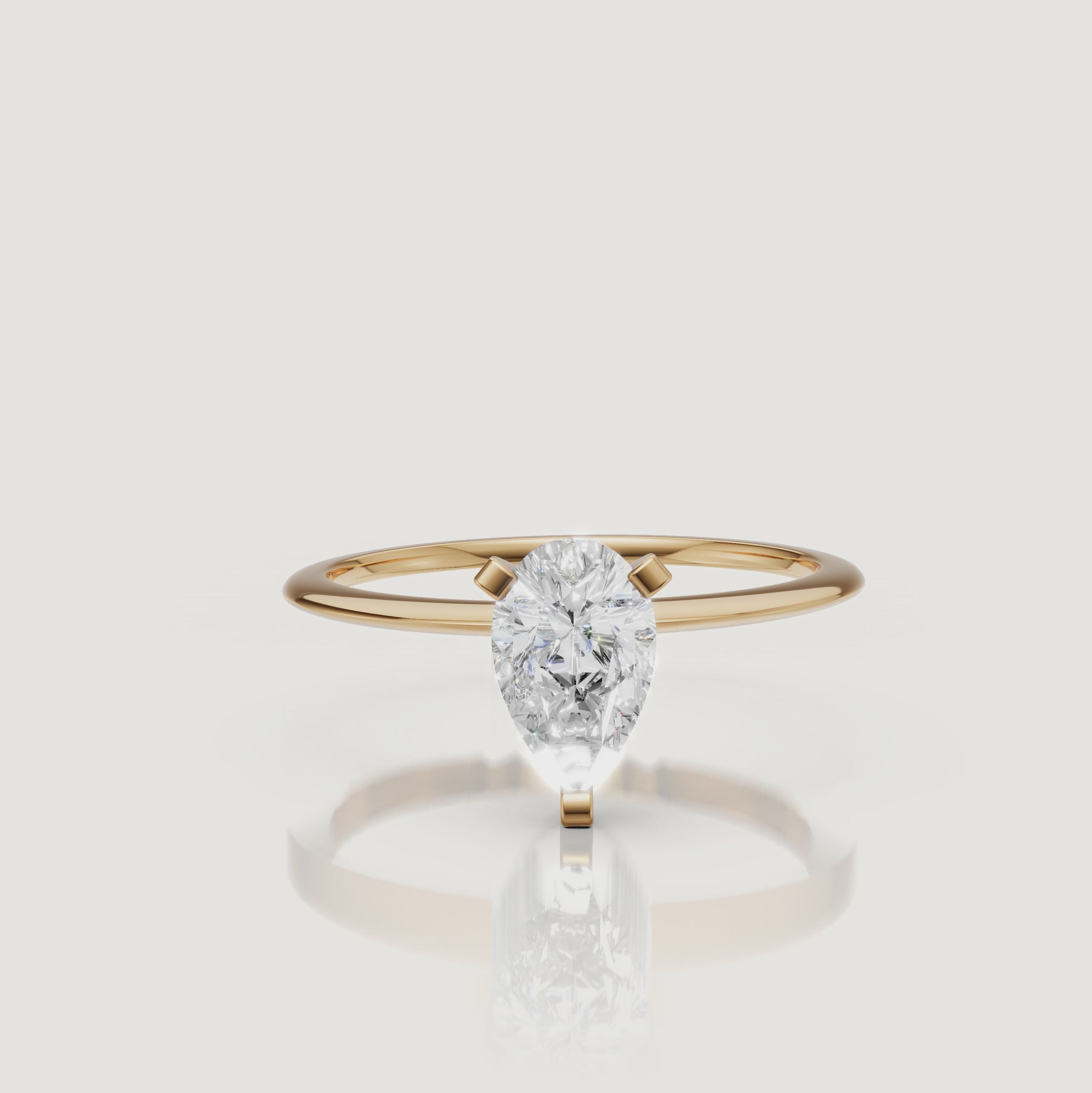 Cinematic video of a pear cut lab grown diamond solitaire engagement ring in yellow gold by Raul Diamonds featuring elegant hand movement, macro diamond sparkle, warm luxury lighting, and premium bridal jewelry styling