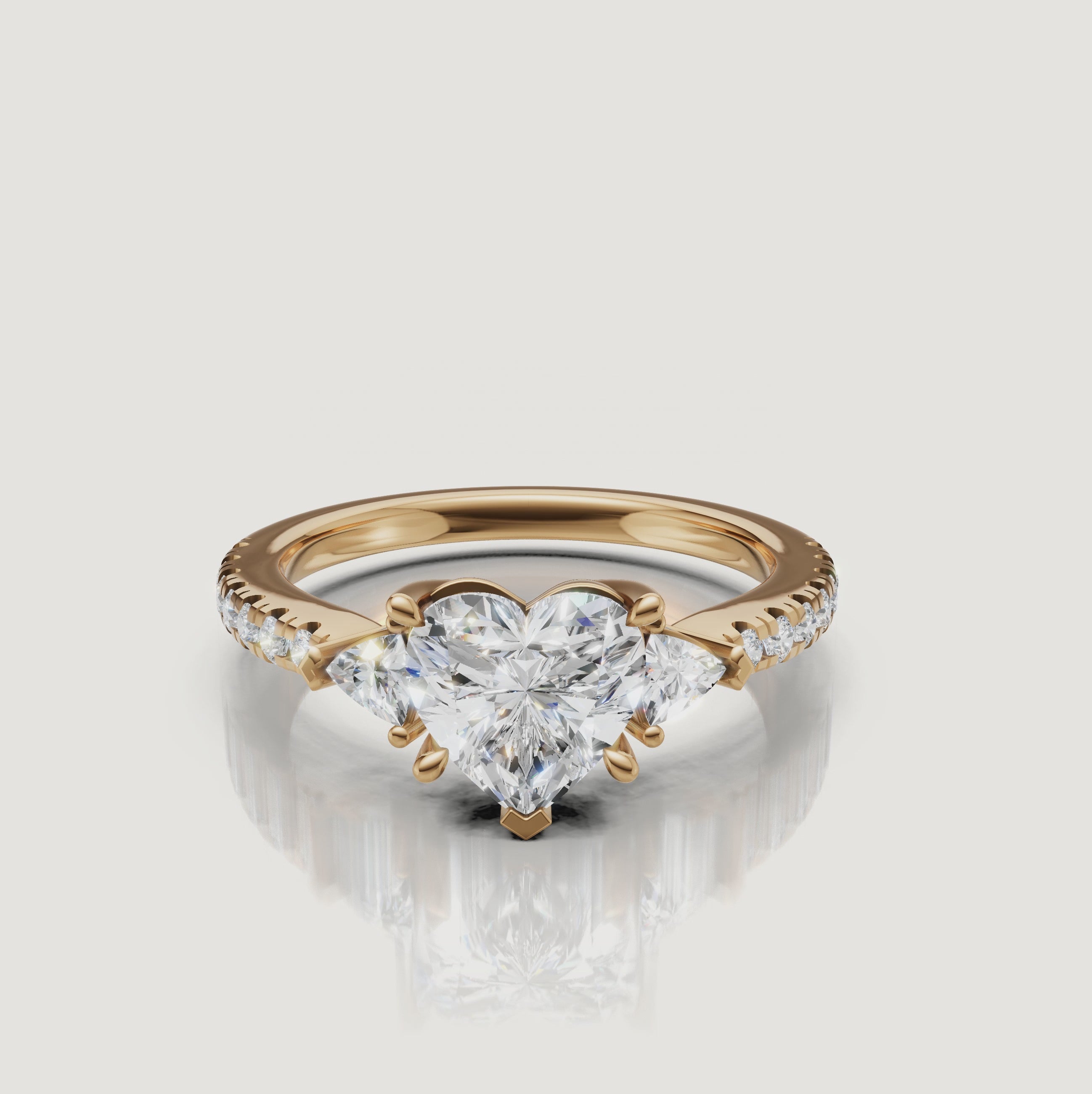 High-definition 360-degree rotation of a Rual Diamonds heart-shaped engagement ring, showing the brilliant trillion side stones and shimmering pavé shank