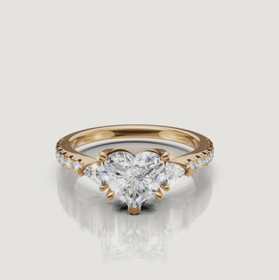 High-definition 360-degree rotation of a Rual Diamonds heart-shaped engagement ring, showing the brilliant trillion side stones and shimmering pavé shank