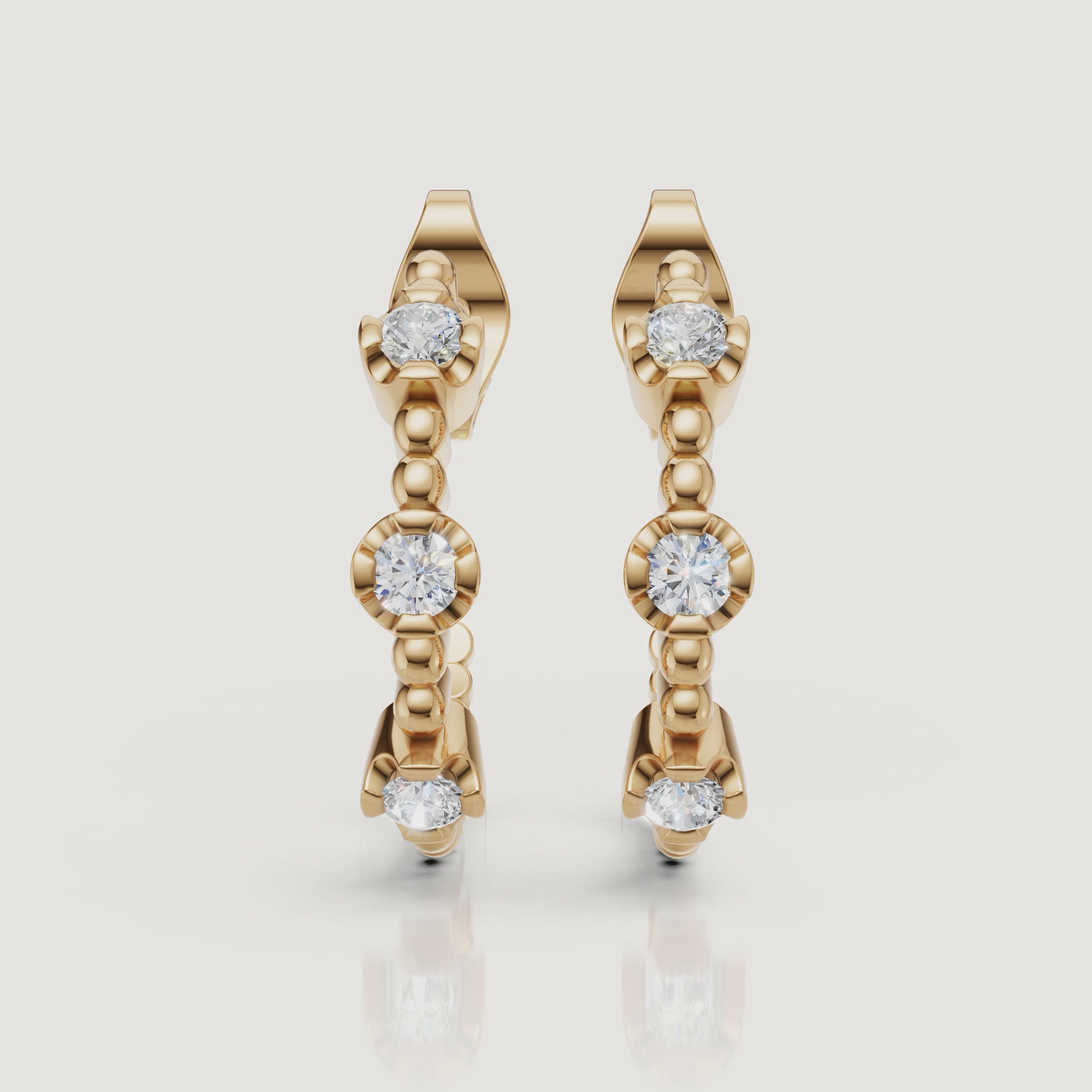 Yellow gold diamond hoop earrings video with bezel set round diamonds by Raul Diamonds