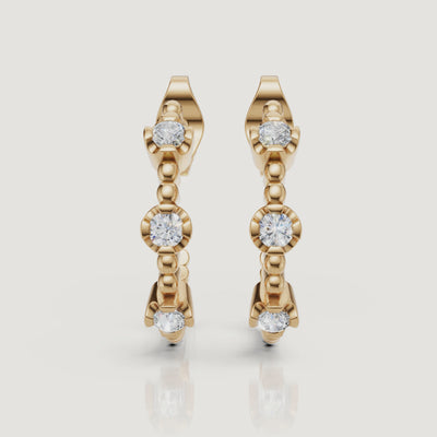 Yellow gold diamond hoop earrings video with bezel set round diamonds by Raul Diamonds
