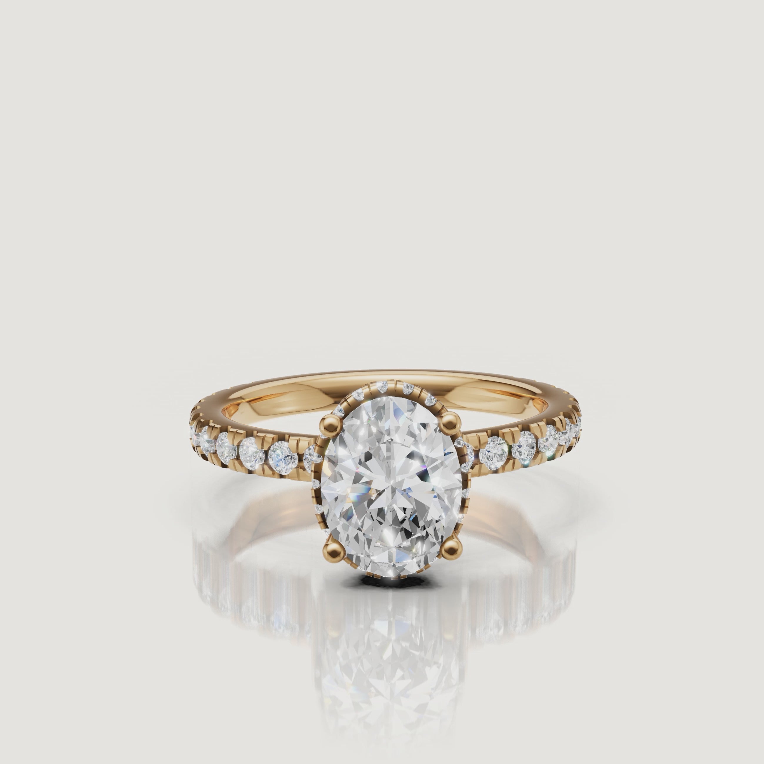 luxurious oval cut lab grown diamond engagement ring rotating video in 14k gold with hidden halo and pavé diamond band sparkling from every angle