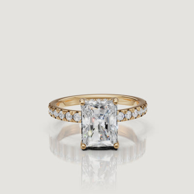 360-degree video showcase of a Raul Diamonds radiant-cut engagement ring in yellow gold, demonstrating the intense light reflection and brilliant pavé diamond band