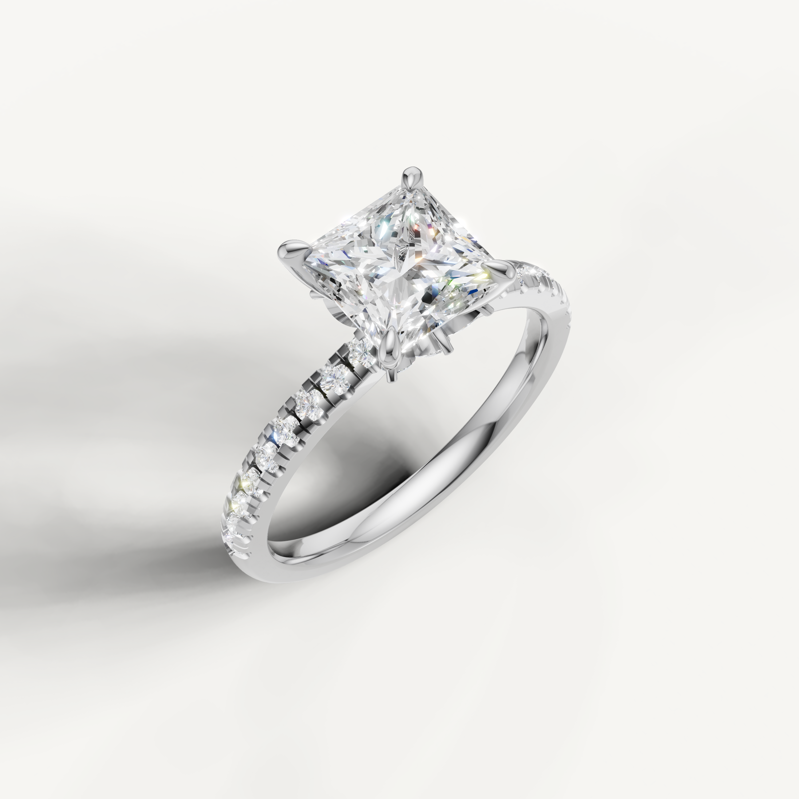 Brilliant white gold princess cut diamond ring featuring a crisp hidden halo and a continuous pavé-set diamond shank.