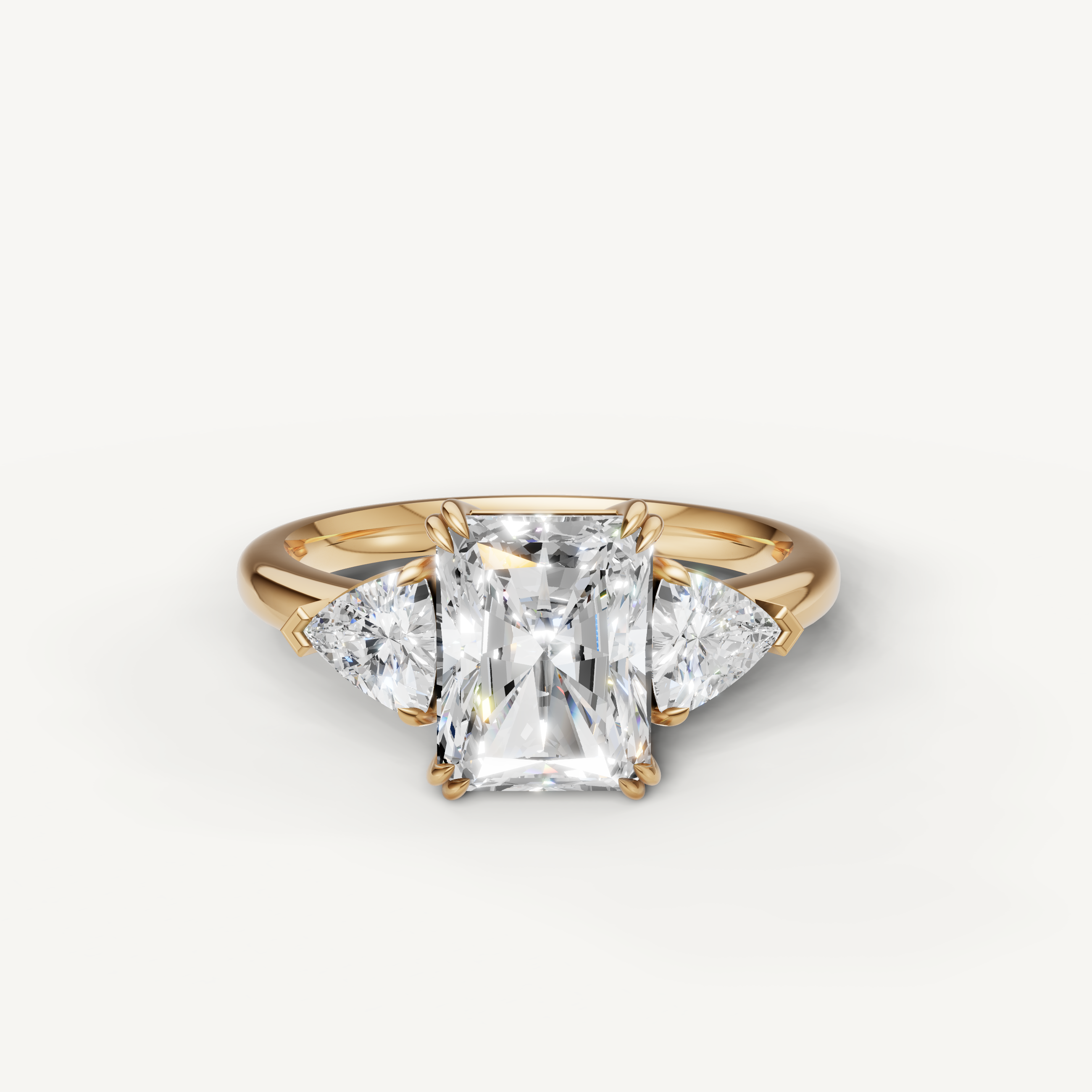 radiant cut lab grown diamond engagement ring with trillion side stones in 14k yellow gold