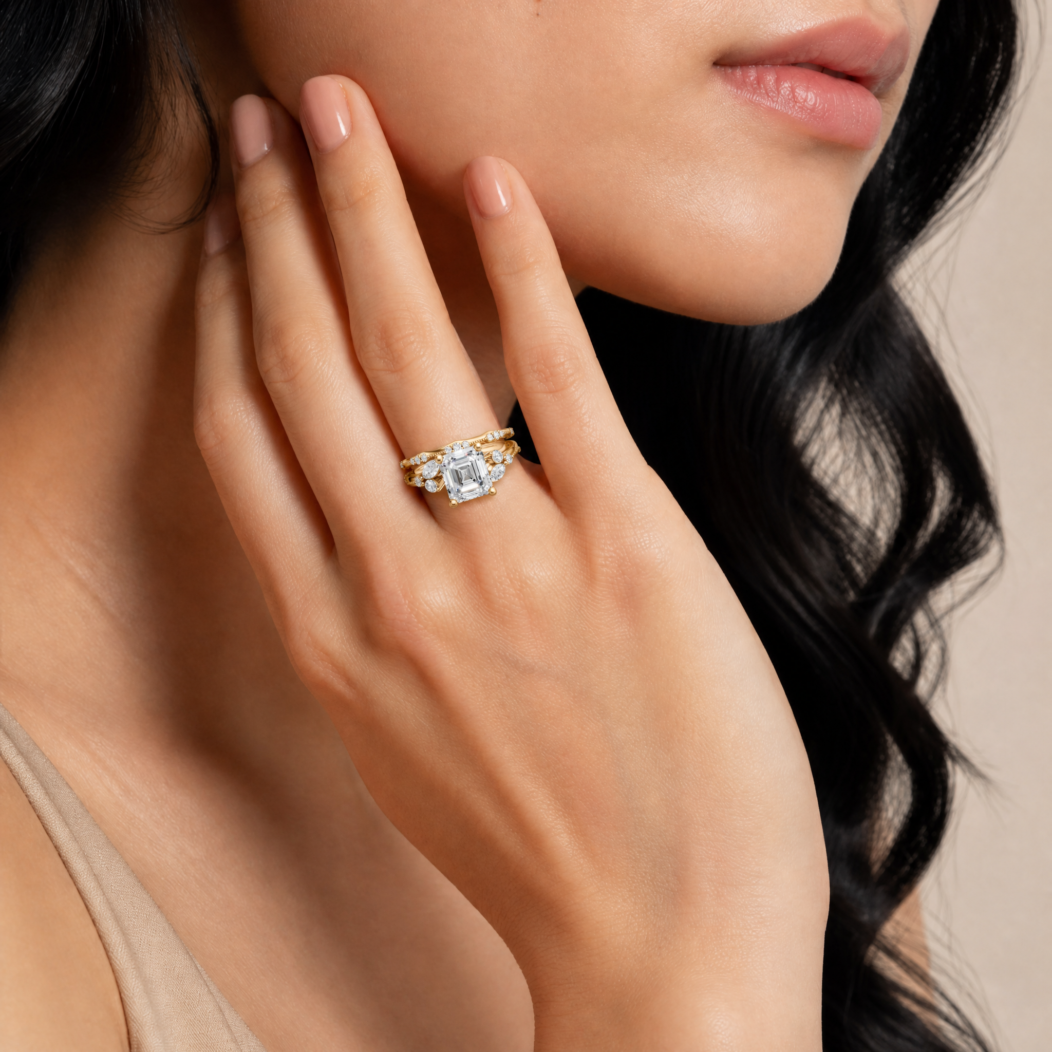 Model wearing Raul Diamonds asscher cut lab grown diamond bridal set in 14K yellow gold with matching pavé wedding bands and vintage-inspired elegance