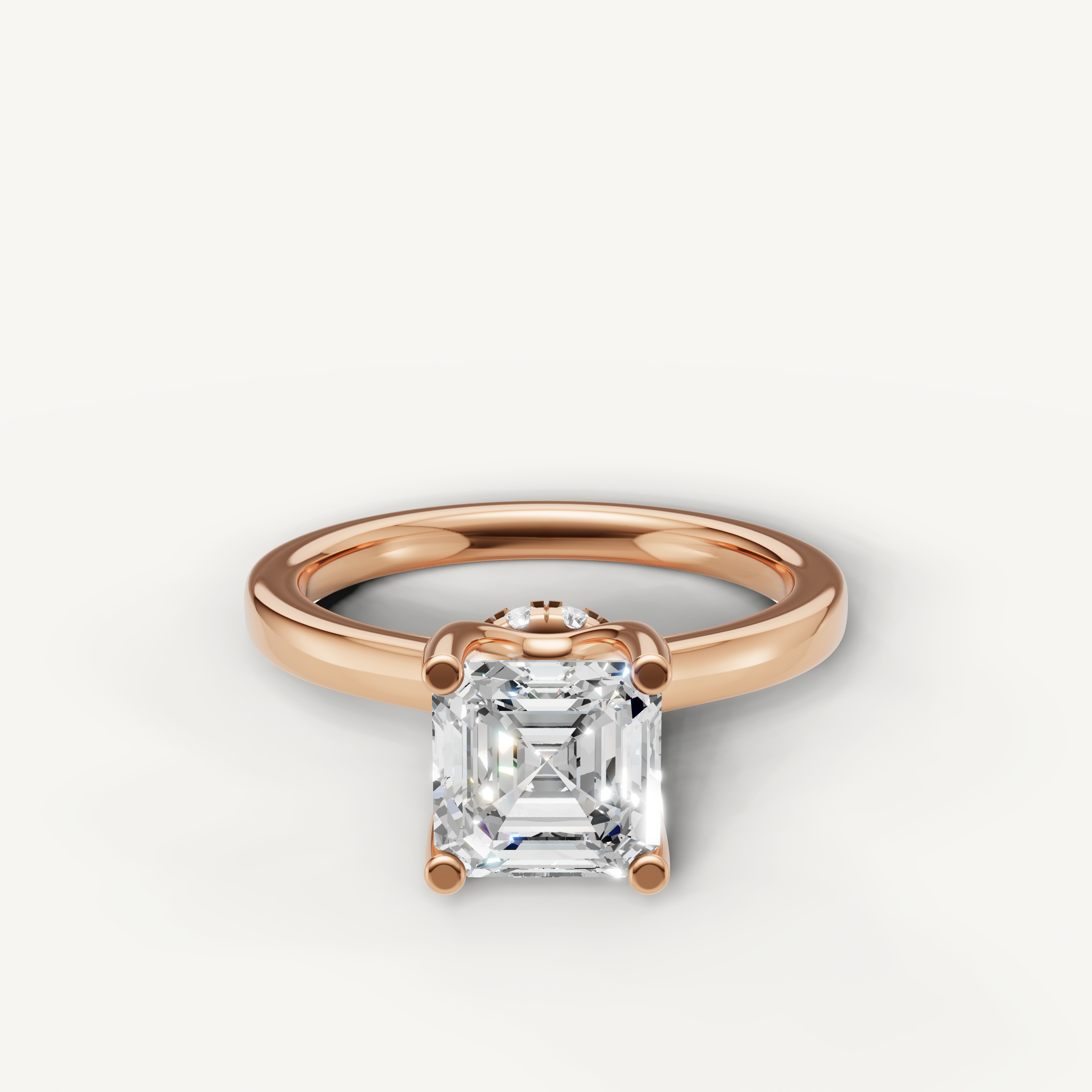 A romantic and modern engagement ring crafted in blushing 14k rose gold, featuring a striking Asscher-cut diamond held by delicate prongs.