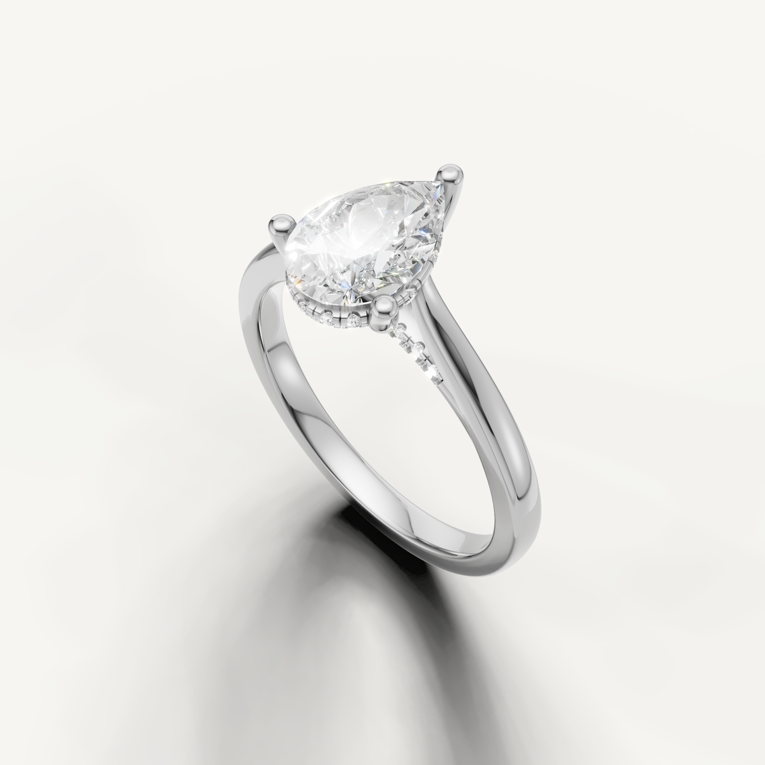 White gold pear-cut lab-grown diamond solitaire ring with pavé hidden halo setting