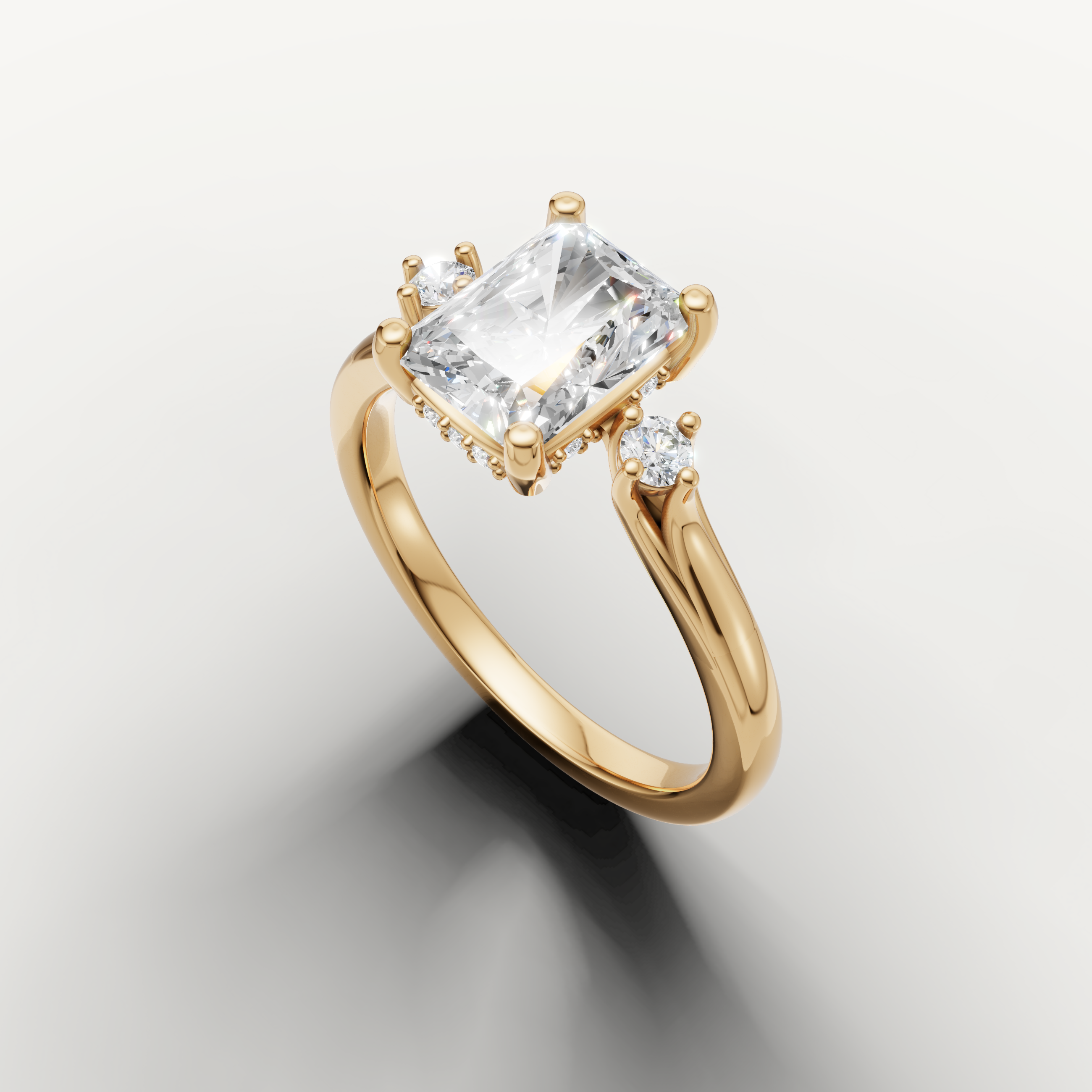 Raul Diamonds yellow gold radiant engagement ring with timeless three stone design