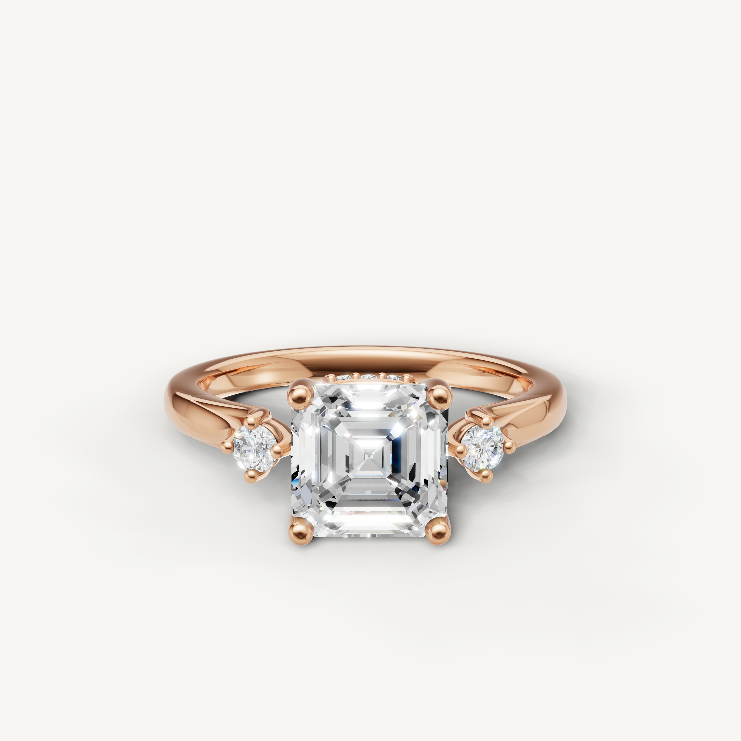 Asscher cut lab grown diamond engagement ring with round side stones in 14K rose gold by Raul Diamonds