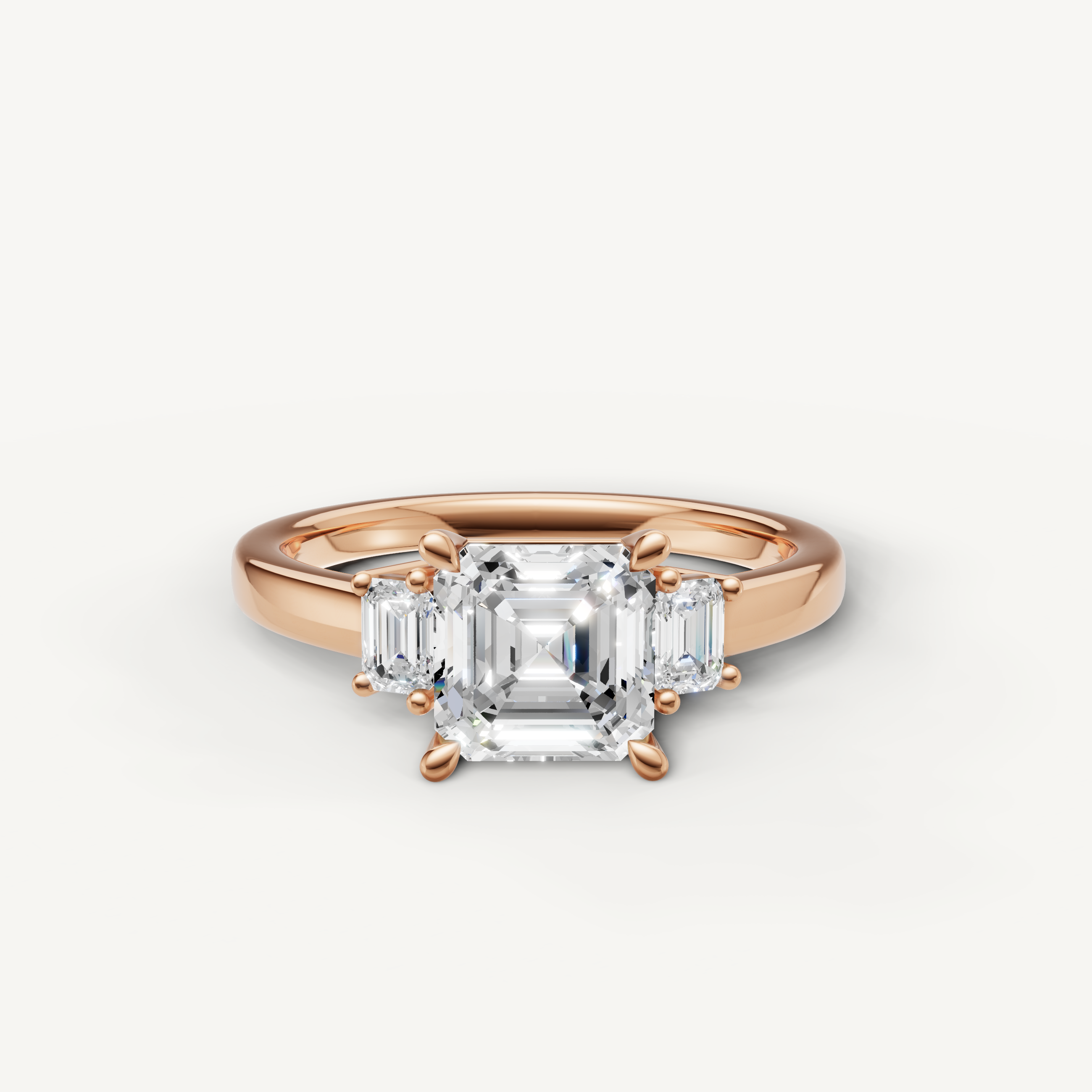 Asscher cut lab grown diamond three stone engagement ring in 14K rose gold with trapezoid side stones