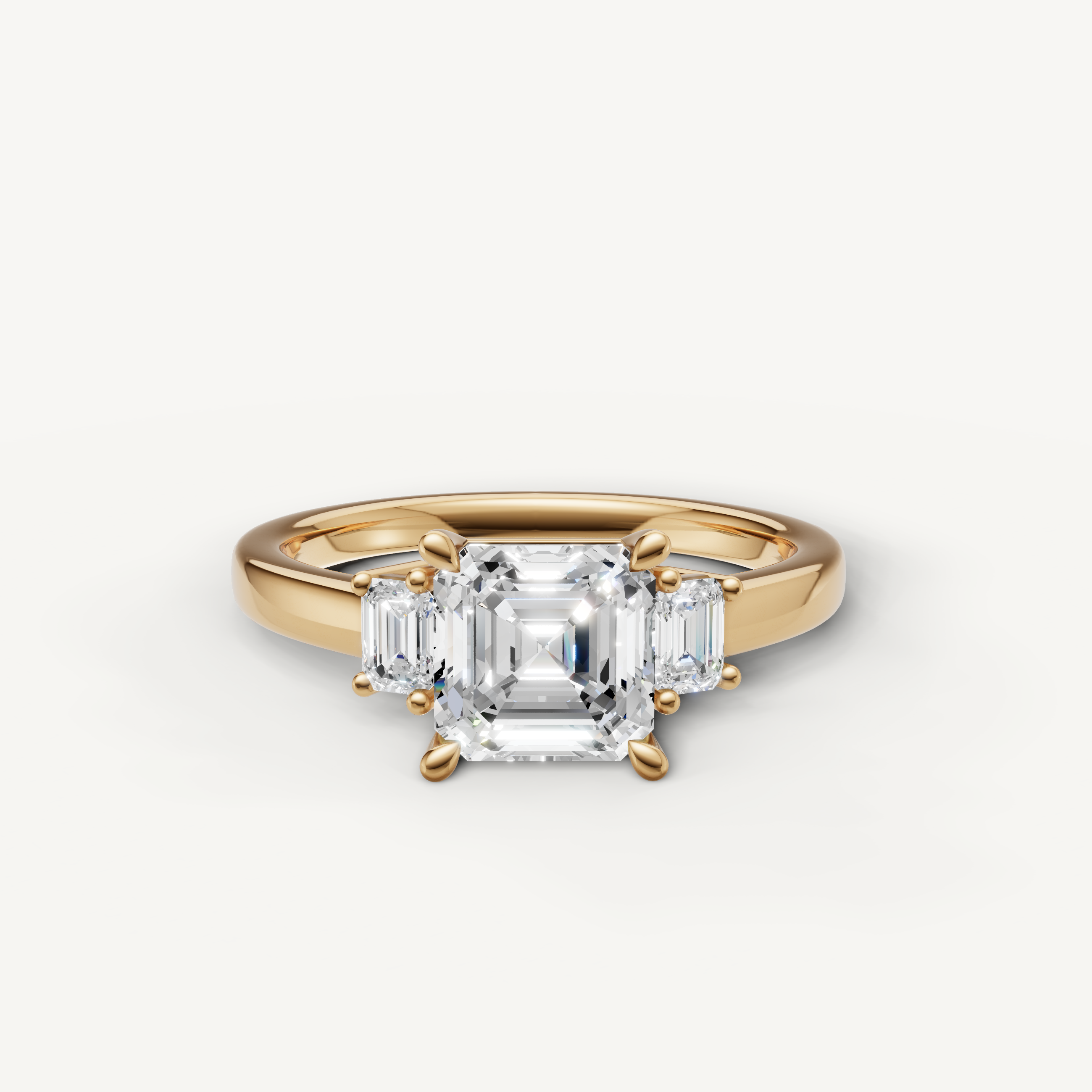 Asscher cut lab grown diamond three stone engagement ring in 14K yellow gold with trapezoid side stones