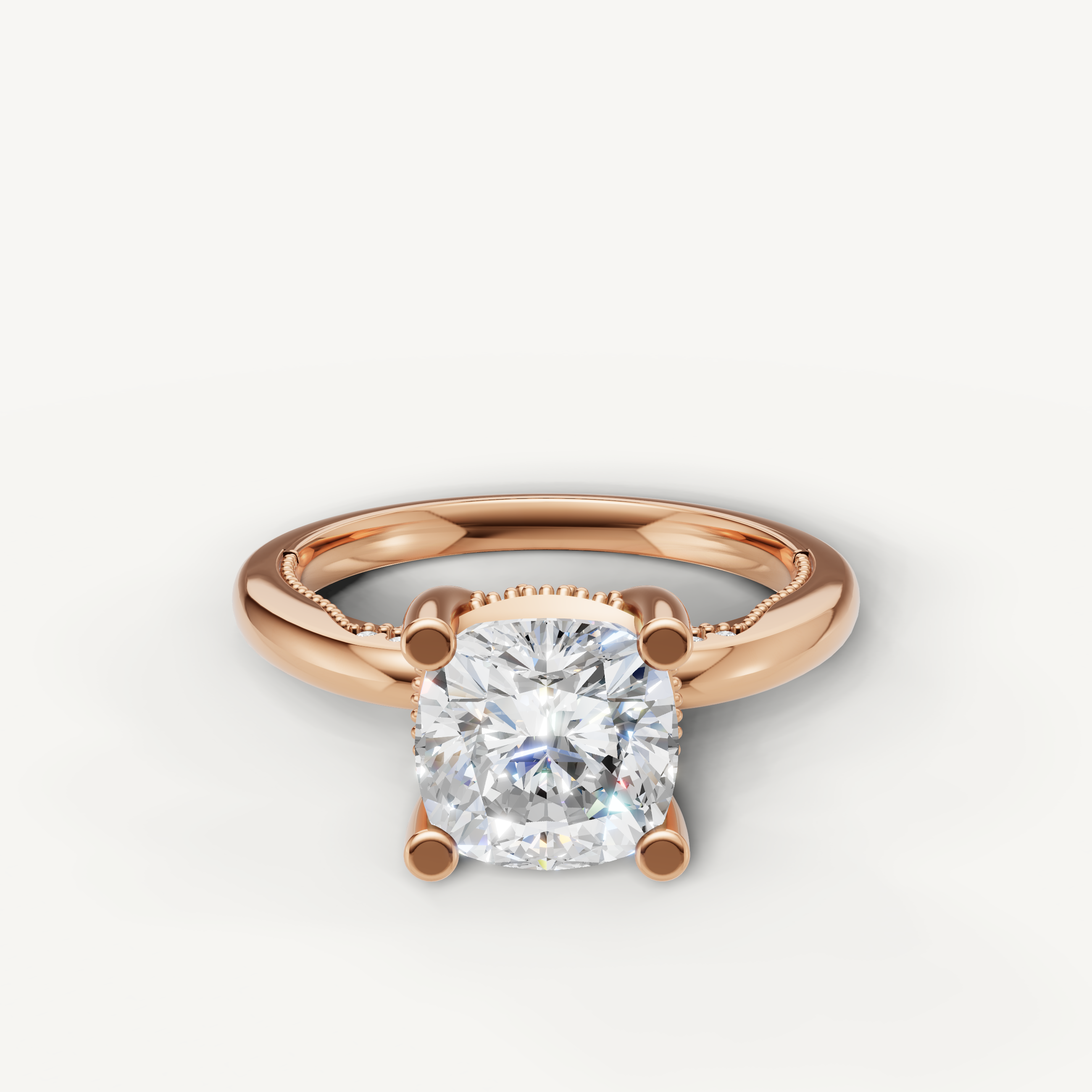 A romantic solitaire engagement ring in 14k rose gold, featuring a dazzling cushion-cut diamond held by four prongs.
