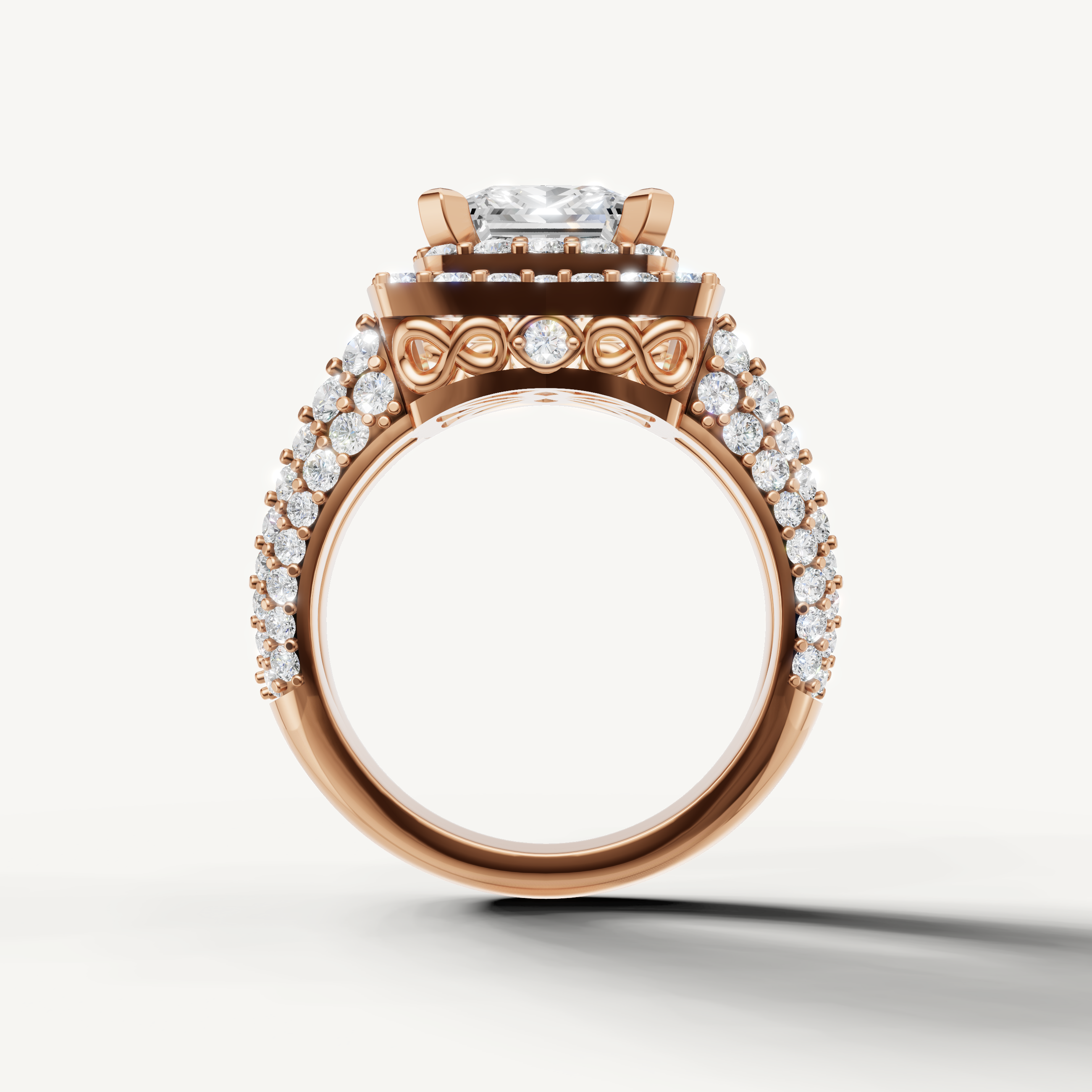 Rose gold princess engagement ring with cushion halo inspired setting.